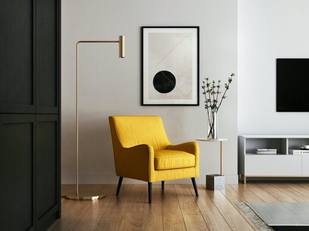 Yellow armchair beside a floor lamp in a calm, light room