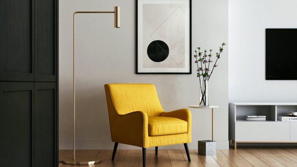 Yellow armchair beside a floor lamp in a calm, light room